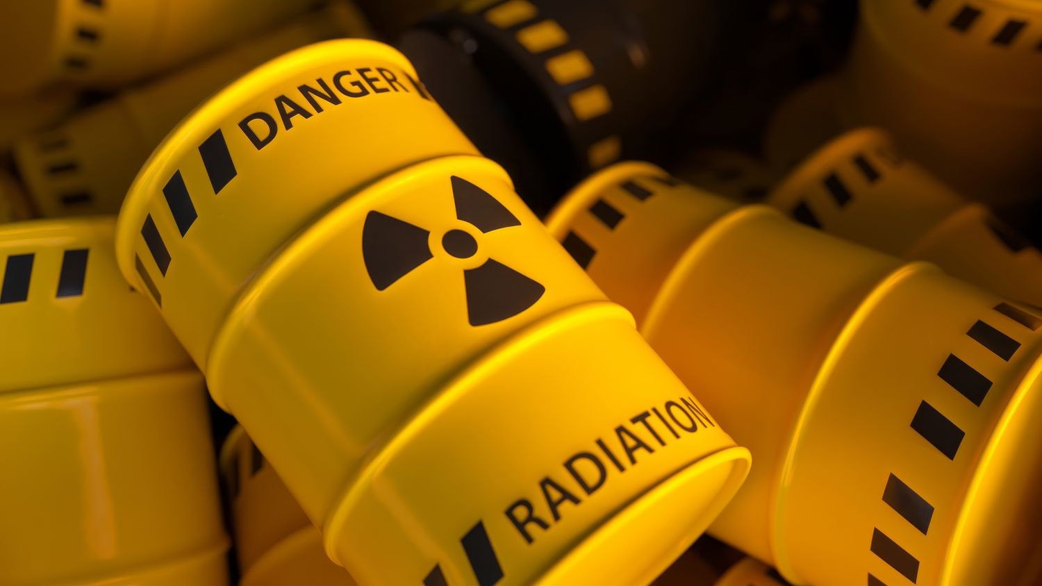 Dump of yellow and black barrels with nuclear radioactive waste. Danger of radiation contamination of industrial containers. 3D illustration.