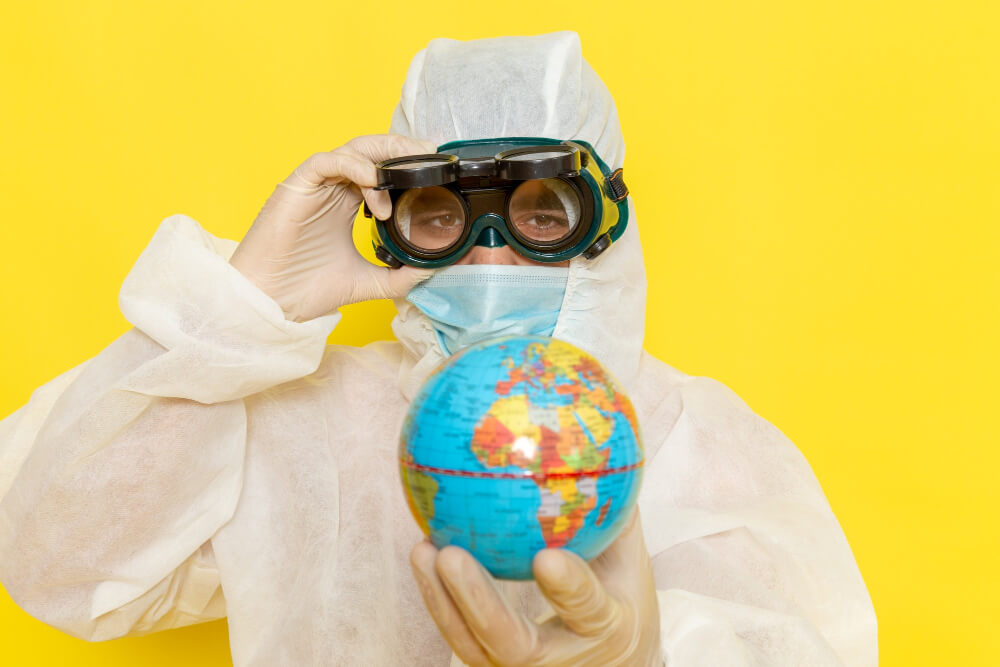 Front view male scientific worker special suit holding little round globe yellow surface.