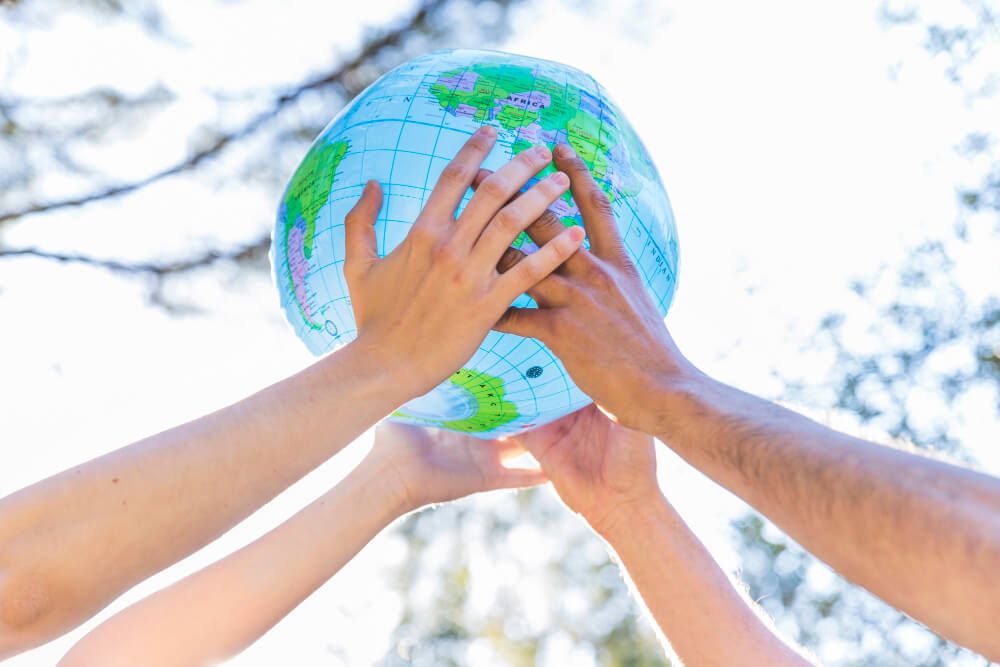 Hands holding inflatable globe.