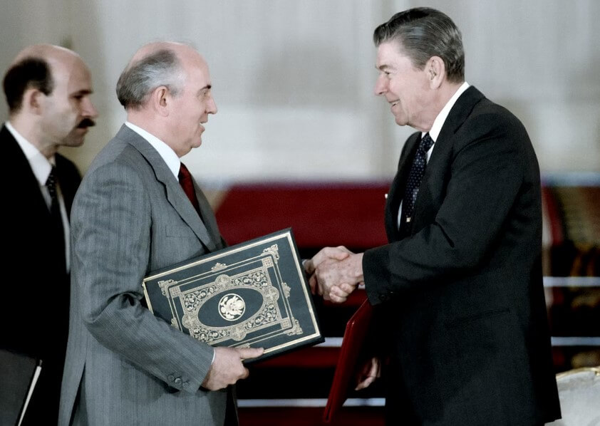 Ronald Reagan shaking hands with Mikhail Gorbachev.