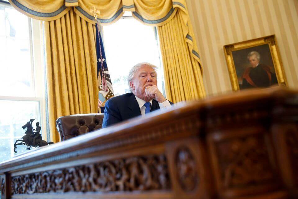 U.S. President Donald Trump pauses during an an interview with Reuters in the Oval Office.