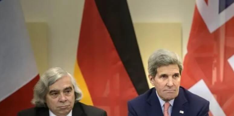 US Secretary of Energy, Ernest Moniz, left, and US Secretary of State, John Kerry wait for the start of a trilateral meeting.